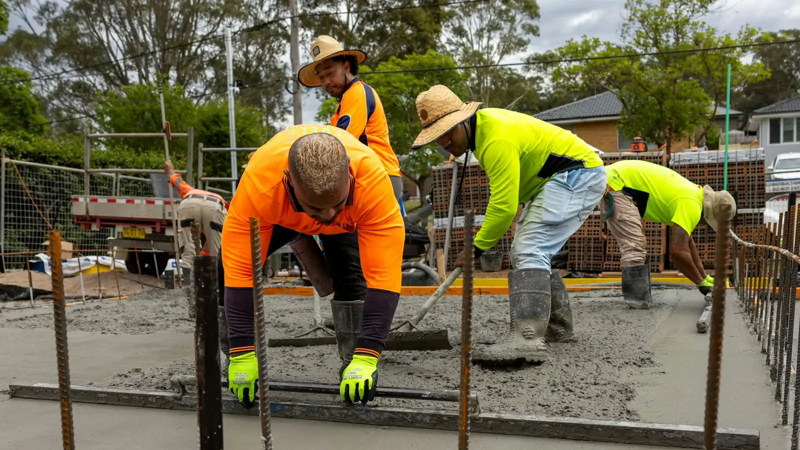 Concrete crew placing and finishing a slab